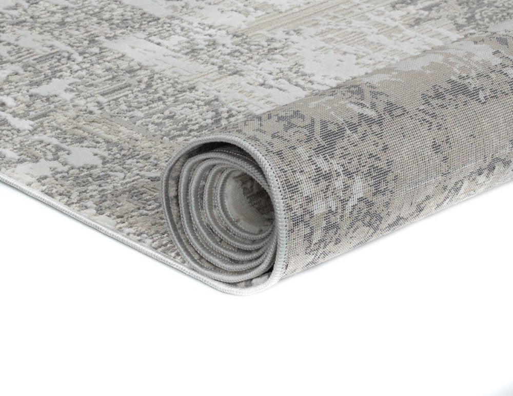 Rolled-up patterned rug on a white background