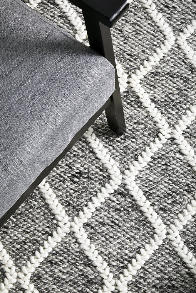 Detailed view of the Huxley Rug's texture in Grey, highlighting the luxurious blend of wool and polyester, and the quality of its hand-loomed construction.