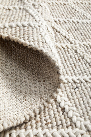 Focused image showing the fine craftsmanship of the Huxley Natural Rug, highlighting the skillful hand-loomed construction and quality materials.