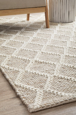 Detailed view of the Huxley Natural Rug's texture, emphasizing the luxurious and soft blend of wool and polyester, perfect for a comfortable underfoot experience.