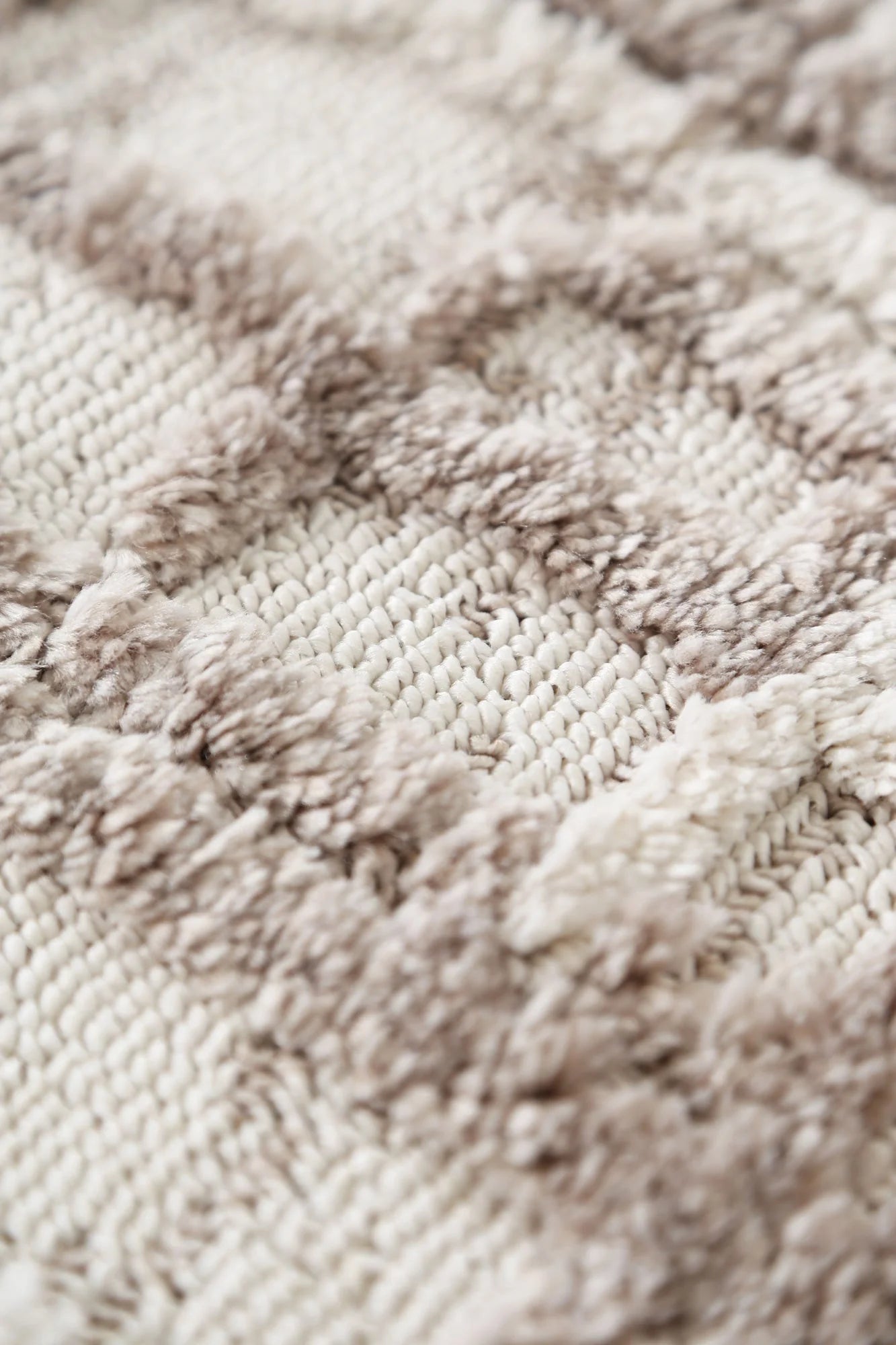 Close-up image focusing on the soft looped pile texture of the Bilbao rug.