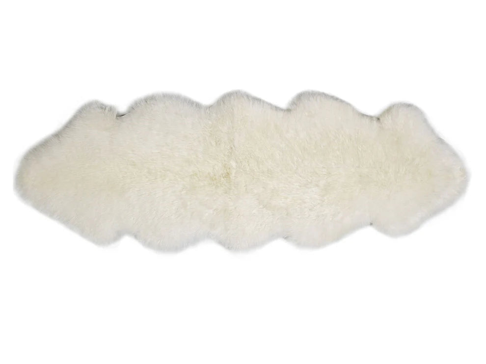 White double sheepskin rug on a white background