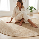 woman sitting on jack outdoor rug inside modern home