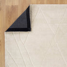 Beige geometric-patterned rug on a wooden floor
