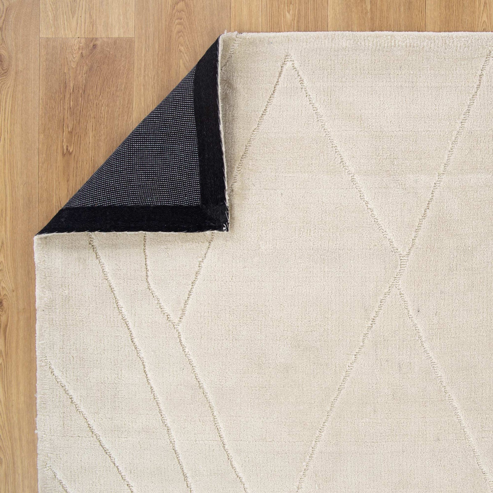 Beige geometric-patterned rug on a wooden floor