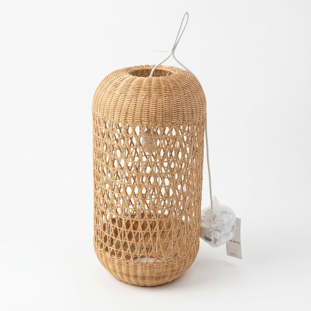 A natural woven rattan or wicker cylindrical lantern with an openwork pattern, shown on a clean white background with a hanging tag.