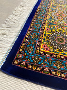 Close-up of a colorful patterned rug with fringes on a neutral background