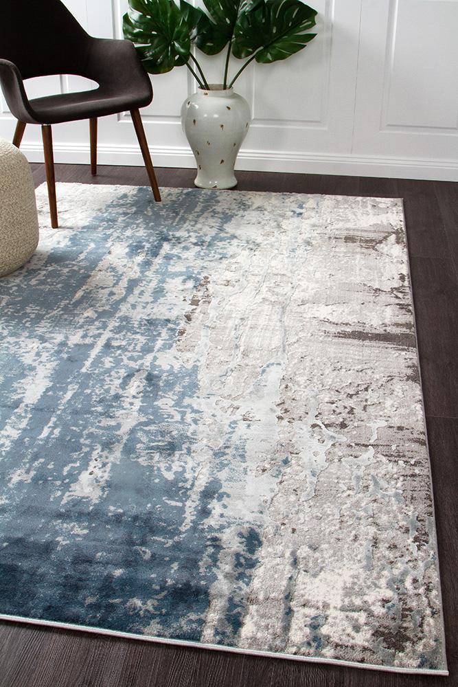 The Kendra Rug in Blue, displayed in a modern room setting, demonstrating its ability to add vibrant colour and style to any space.