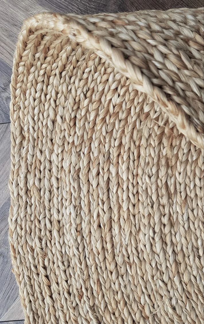 Close-up of a textured woven mat on a wooden floor