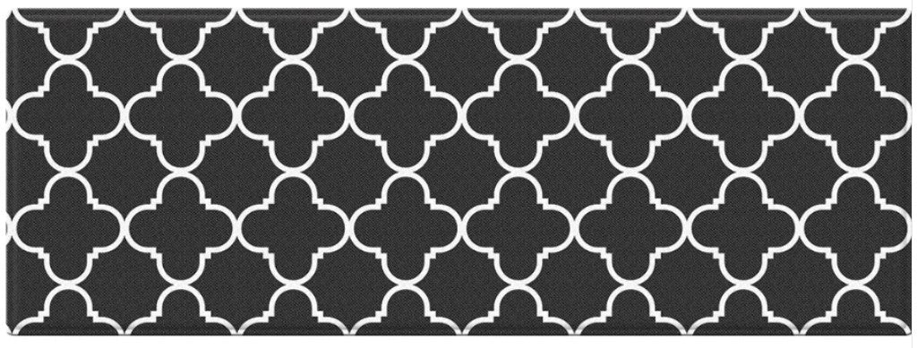 Black and white geometric patterned rug with clover-like shapes