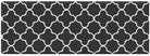 Black and white geometric patterned rug with clover-like shapes