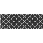A rectangular black rug with a white geometric quatrefoil trellis pattern, shown against a plain white background.
