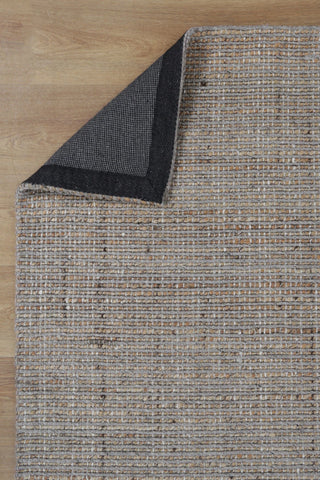 The Dune Jute & Wool Rug folded to display both its top and bottom surfaces, illustrating the consistent finish and quality craftsmanship.