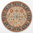 A round traditional area rug with an intricate floral and geometric pattern in beige, navy blue, rust red, and light blue, shown flat against a white background.