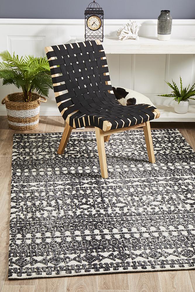 The Levi Rug in Ivory Black elegantly laid out in a room, illustrating how it complements and enhances modern interior decor.