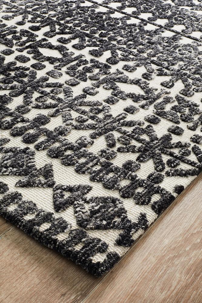 Image focusing on the corner of the Levi Rug in Ivory Black, displaying the precise finish and quality craftsmanship.