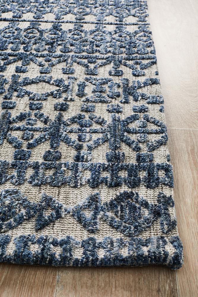 Close-up of the geometric and nomadic figures on the Levi Collection Rug, showcasing the intricate design and color play.