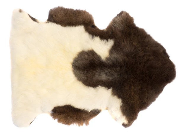 Brown and white fur rug on a white background