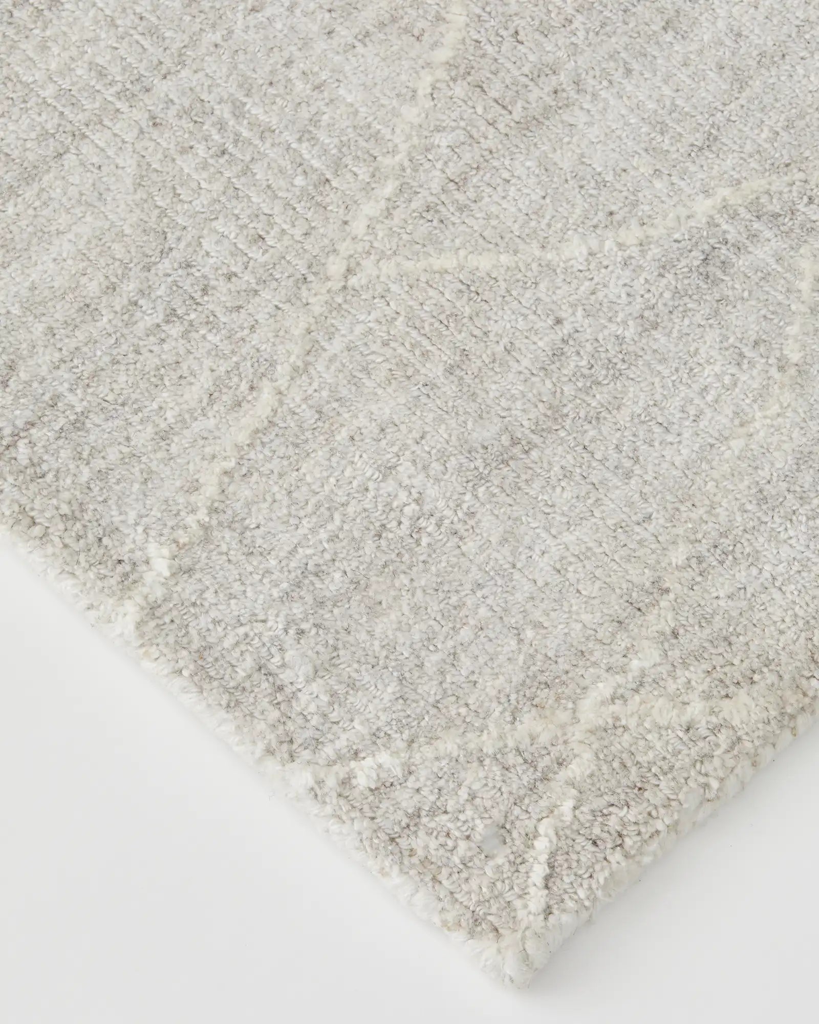 Angle shot of the rug's edge, showing the fine finishing and loom-knotted details.
