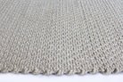Close-up of a textured beige carpet on a white background