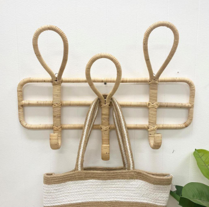 Wicker wall hook with a woven basket on a white background