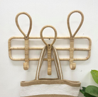 Wicker wall hook with a woven basket on a white background