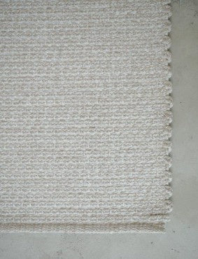 Textured white rug on a light gray floor