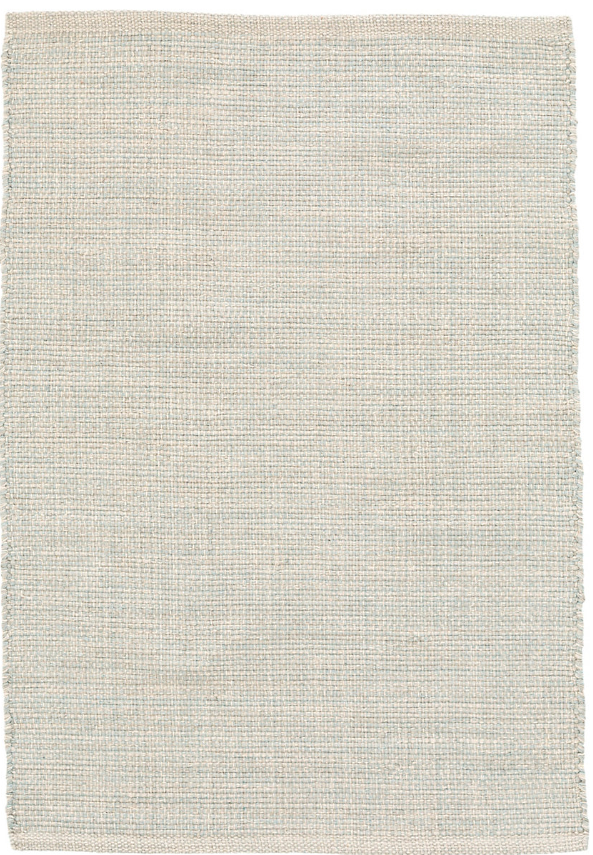 Textured beige rug with a subtle pattern on a plain background