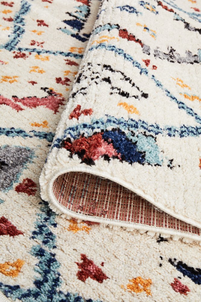 The Marrakesh Rug in White under natural light, enhancing the vividness and depth of its tribal colours and patterns.