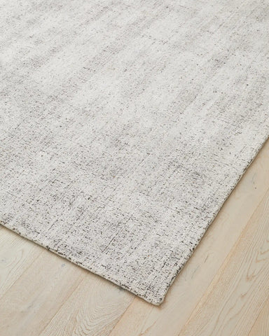Angle shot of the rug, focusing on the loom-knotted craftsmanship and the fine, detailed finish.