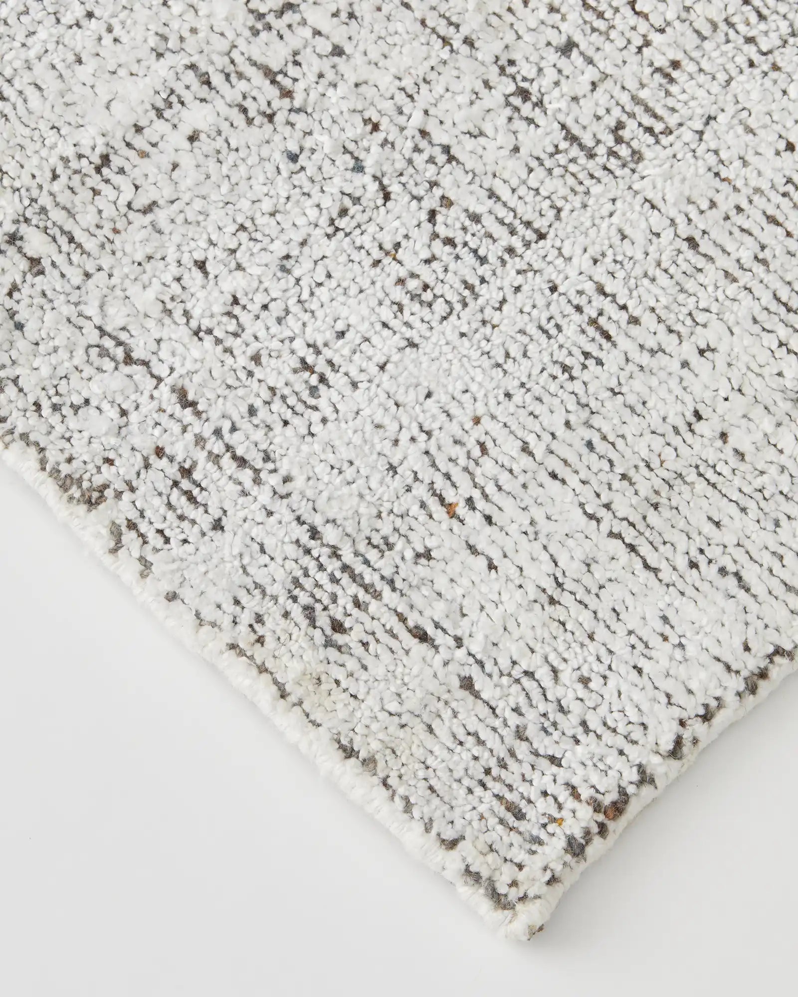 Photo of the rug's edge, displaying the cotton braided edge and full cotton backing for added durability.
