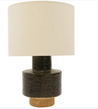Table lamp with a textured brown base and beige lampshade on a white background