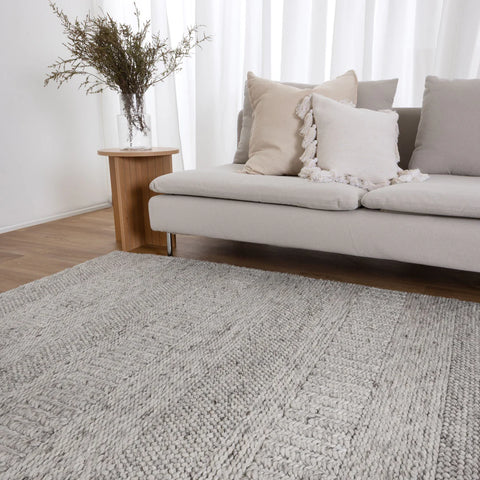 grey/white rug on timber flooring with modern furniture