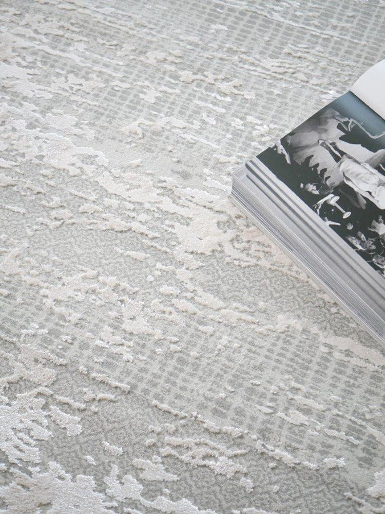 Close-up of a textured gray surface with a book partially visible