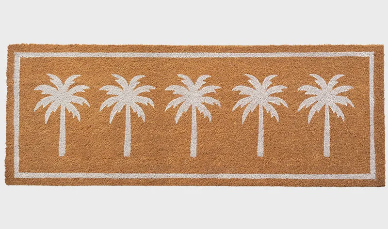 Doormat with white palm tree design on a brown background