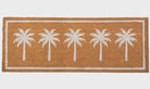 Doormat with white palm tree design on a brown background
