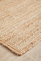 Close-up of a woven jute rug on a wooden floor
