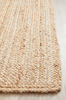 Close-up of a woven jute rug on a wooden floor