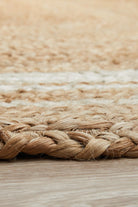 Close-up of a woven jute rug with a natural color palette.