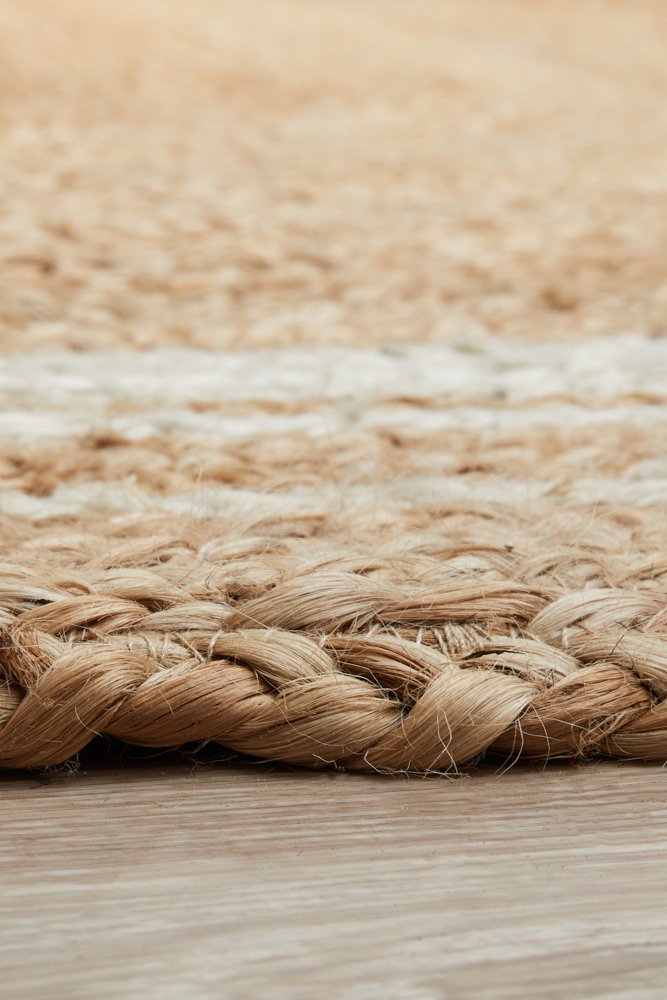 Close-up of a woven jute rug with a natural color palette.