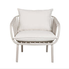 A modern outdoor armchair with a white woven slat frame and thick white cushions, shown against a plain white background.
