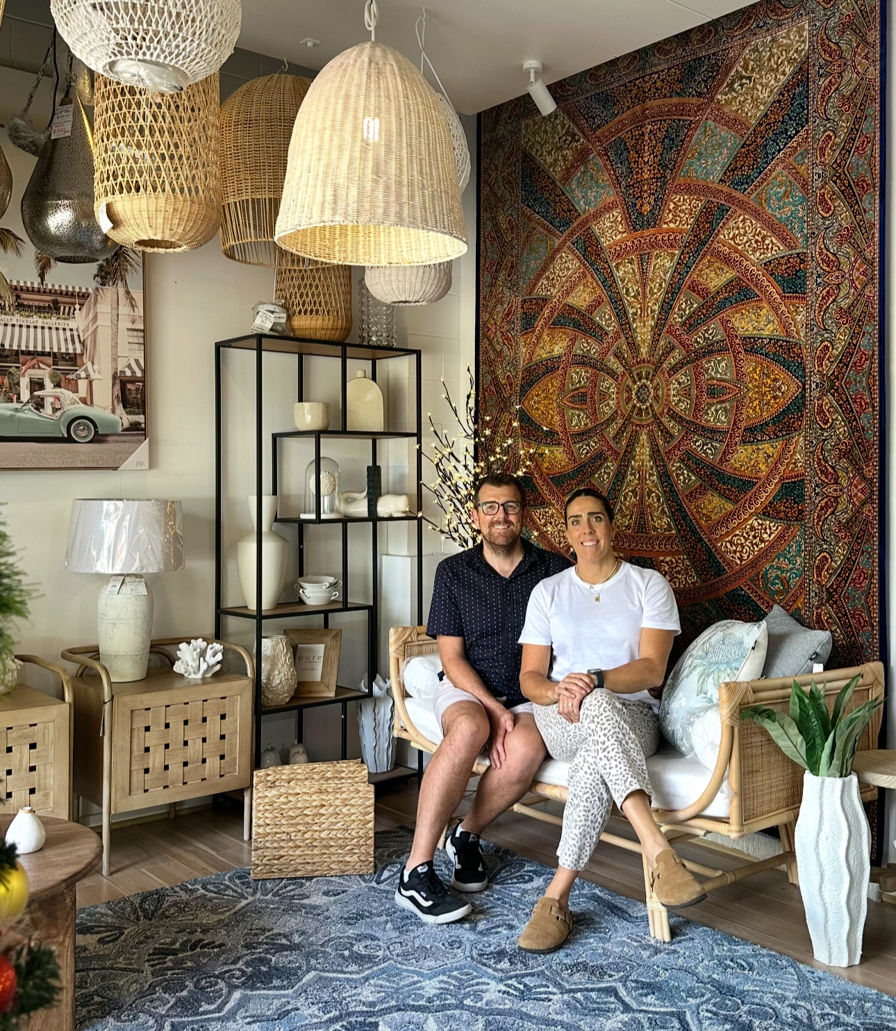 Two people sitting in a stylish interior setting with decorative elements.