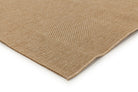 Close-up of a beige woven mat on a white background