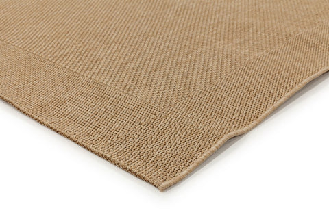 Close-up of a beige woven mat on a white background