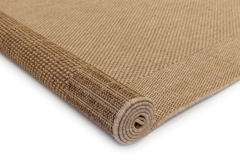 Rolled-up brown woven mat on a white background
