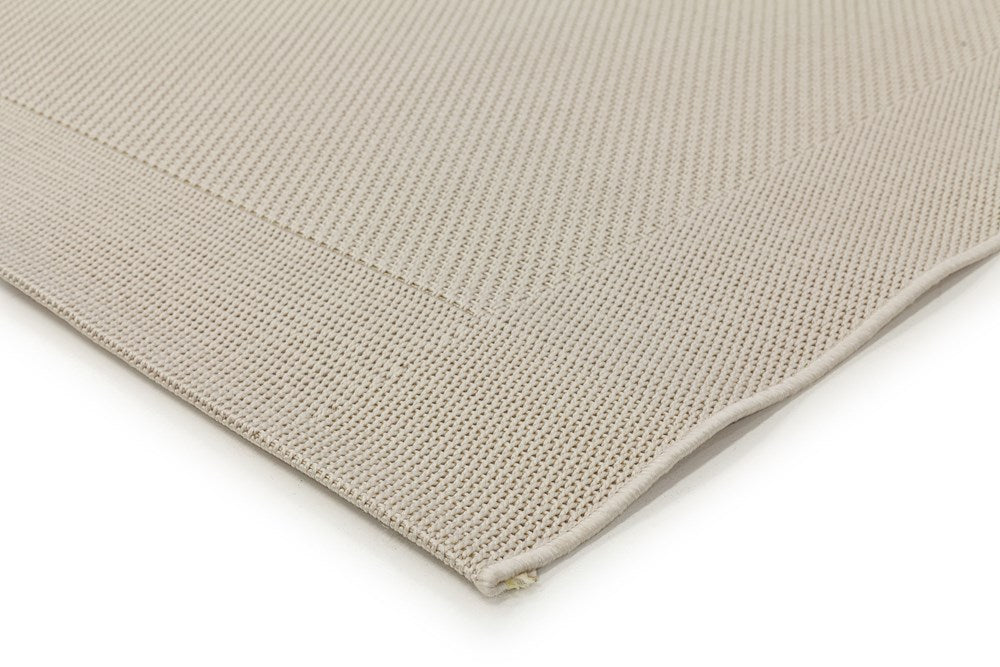 Detailed view of the Noosa Rug's Outdoor Range in Ivory, focusing on the texture and quality of the stain-resistant polypropylene material.