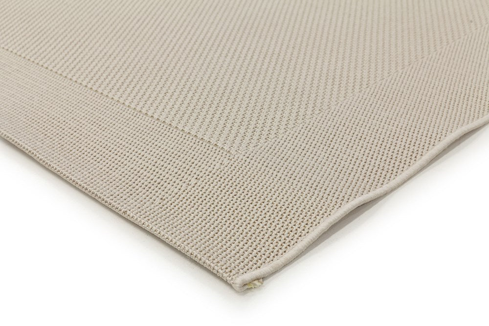 Detailed view of the Noosa Rug's Outdoor Range in Ivory, focusing on the texture and quality of the stain-resistant polypropylene material.
