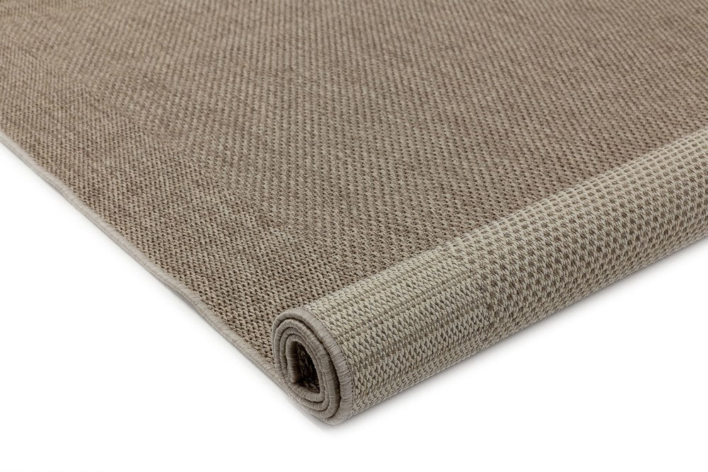 Image of the Outdoor Elegance Rug in Rope color rolled up, displaying both the top and underside, showcasing its versatility and quality construction.