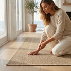 indoor/outdoor rug in rope with a woman touching the rug