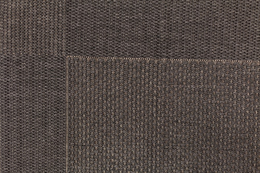 Close-up of brown textured fabric with a visible seam.